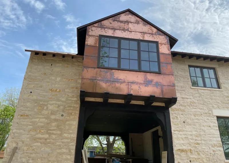 Copper metal panel facade on a stone building for Skylight Installation in Ashland City
